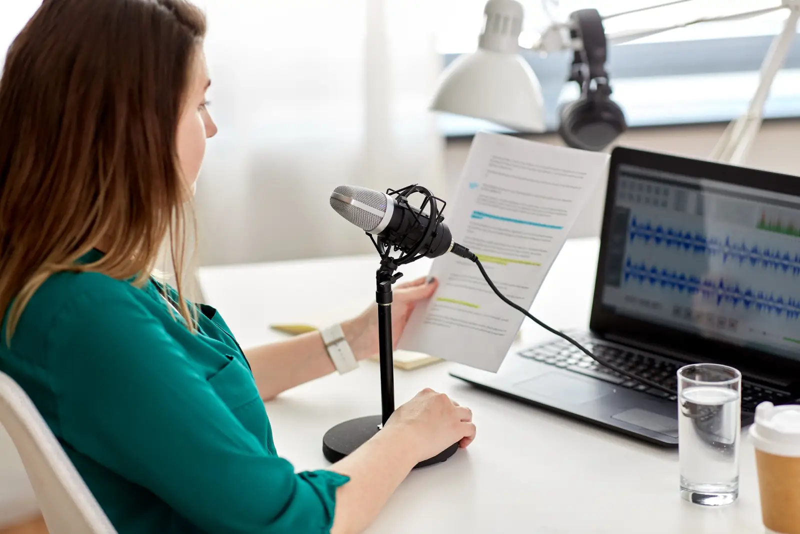woman with microphone recording podcast at studio woman with microphone recording podcast at studio